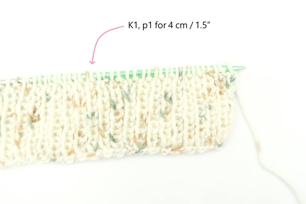Bottom k1 p1 edge of the simple knit sweater pattern