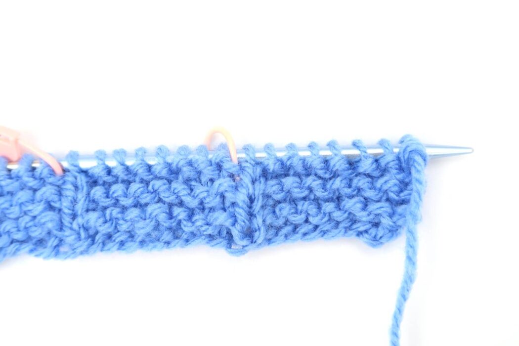 close up of knitting needle creating Vertical Lines stitch