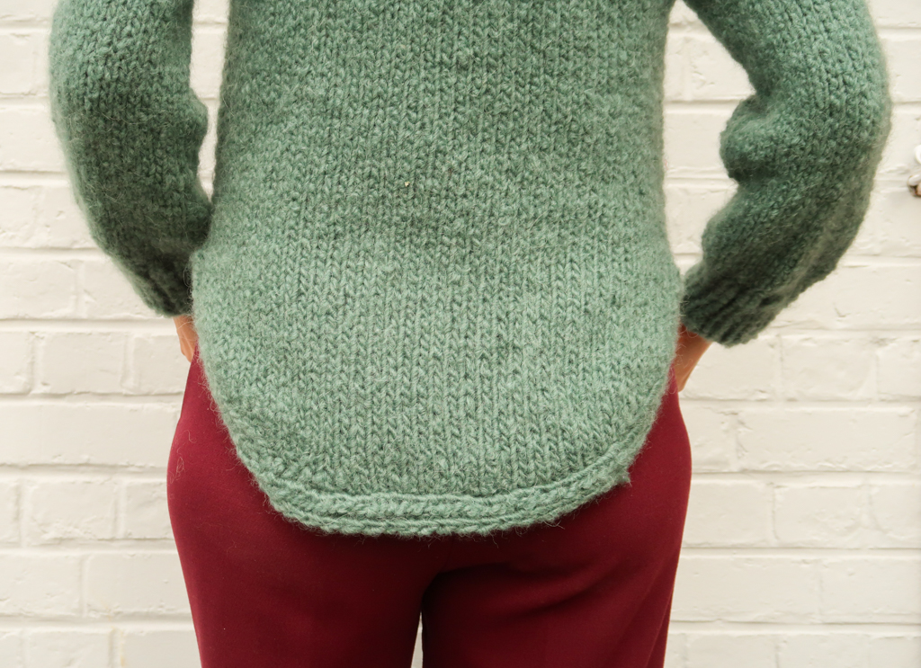 High split hem and rounded bottom edge of the Aurora knit sweater pattern