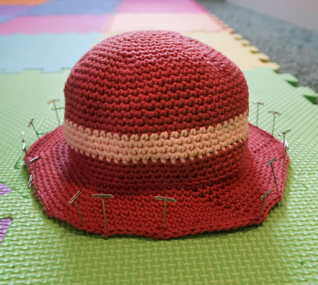 baby crochet hat pinned at the brim to block