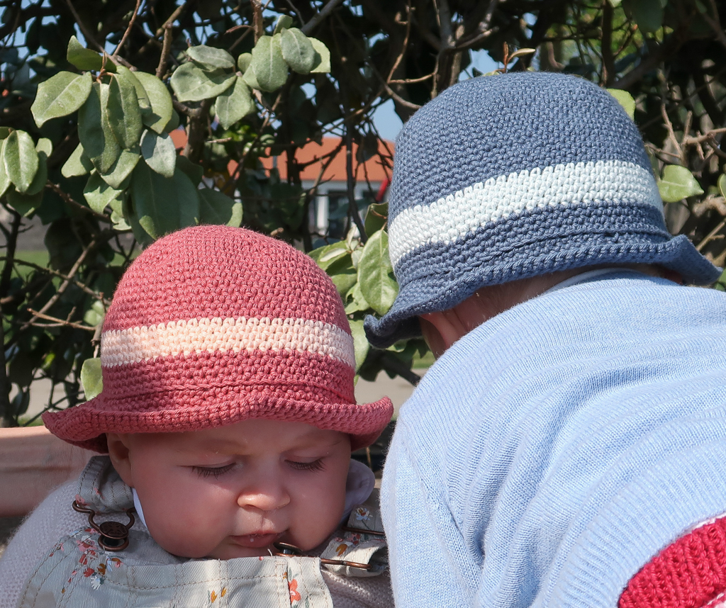 2 babies wearing their finished derby baby sunhats crochet patterns