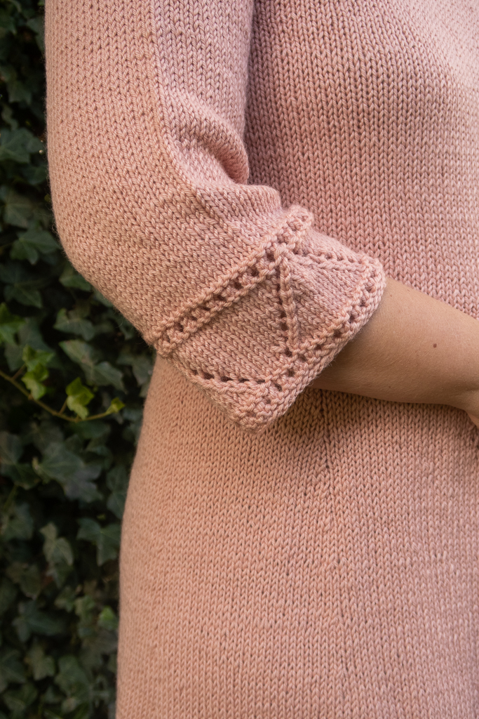 close up view of the lace at the sleeve's cuff of a soft pink knit dress pattern