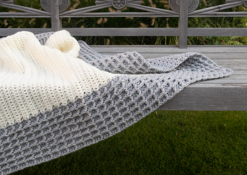 waffle stitch crochet pattern free thrown on a wooden bench
