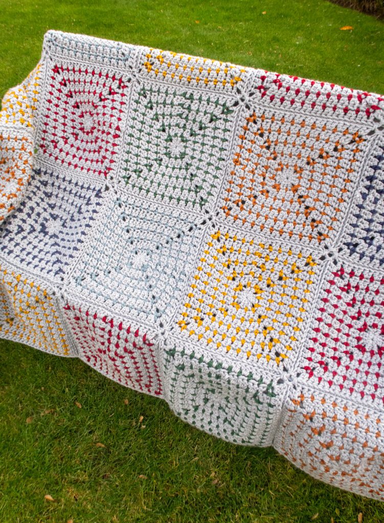 Cozy chunky crochet blanket pattern easy draped on a bench
