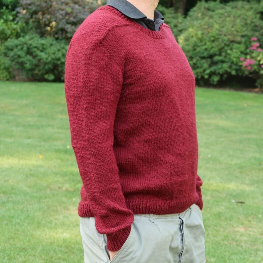 Side view of the tapered sleeve and body of the finished mens knit sweater