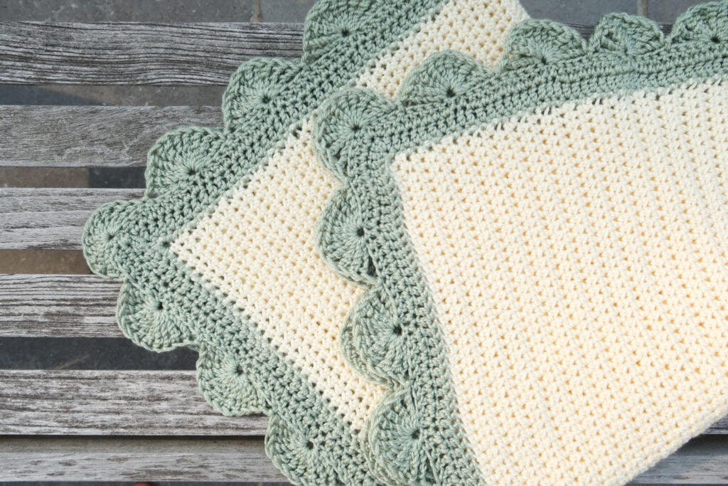 Detailed view of the corner of the 2 color crochet blanket pattern with scalloped crochet edging pattern