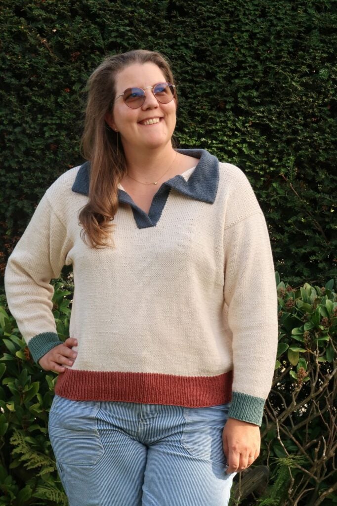 Oversized sweater knitting pattern worn with jeans, showing the relaxed fit