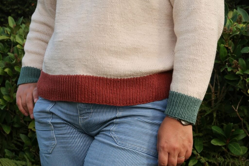 Contrast ribbed hem and cuffs on a top down sweater knitting pattern