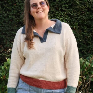 Woman wearing the Harbour Polo Sweater, a polo sweater knitting pattern with a contrast collar
