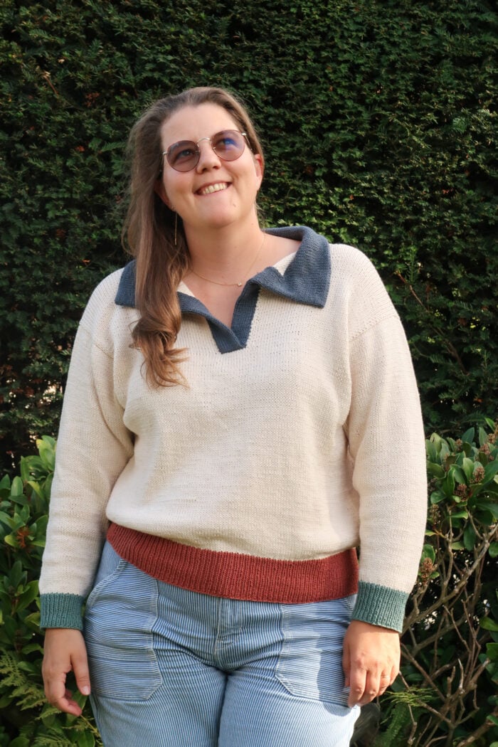 Woman wearing the Harbour Polo Sweater, a polo sweater knitting pattern with a contrast collar
